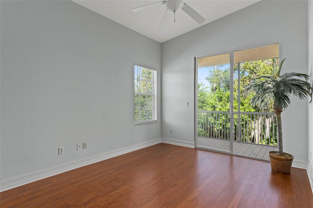 8229 Gulf Way Hudson, FL 34667 - Photo 24 of 35 an empty room with wooden floor and windows