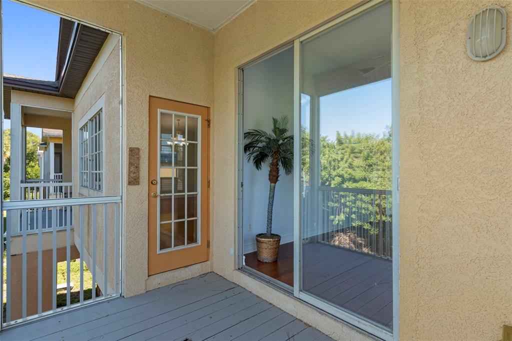 8229 Gulf Way Hudson, FL 34667 - Photo 28 of 35 a view of front door and porch with wooden floor