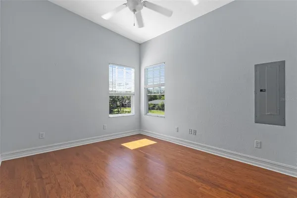 wooden floor in an empty room with a window