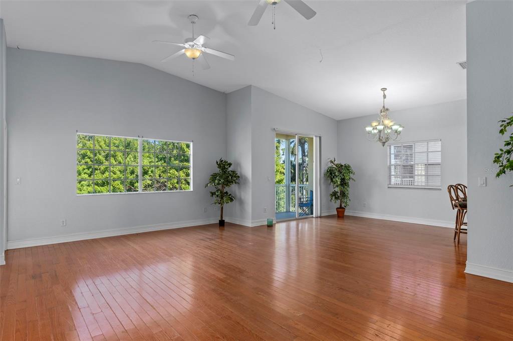 8229 Gulf Way Hudson, FL 34667 - Photo 4 of 35 a view of an empty room with window and wooden floor