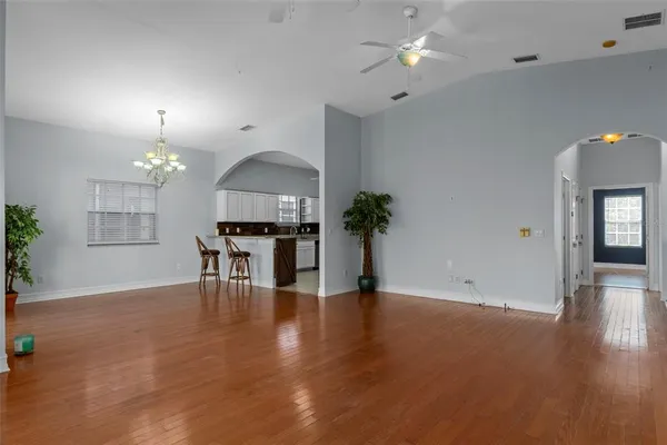 a view of a livingroom with furniture wooden floor and a chandelier