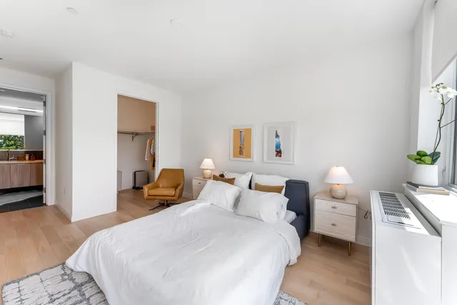 a bedroom with a bed and a couch