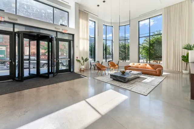 a living room with furniture and large windows