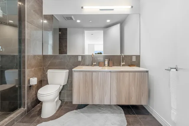 a bathroom with a toilet a sink and a mirror