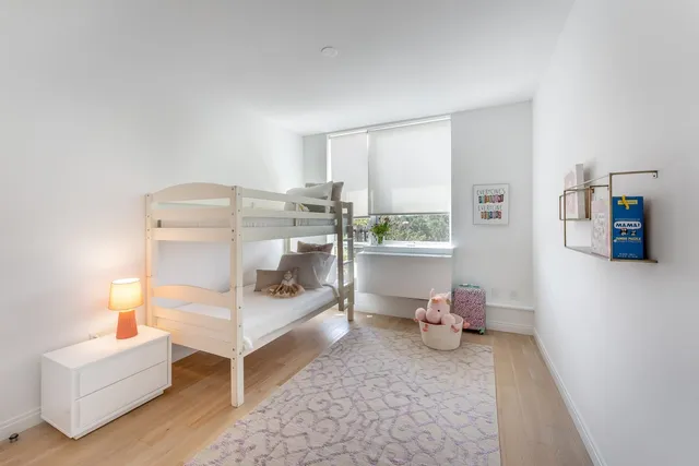 a bedroom with furniture and a window