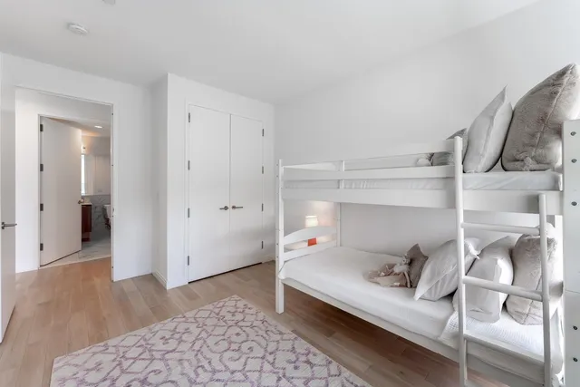 a bedroom with a bed and cabinets