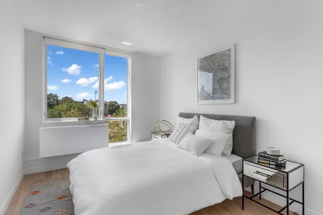 a bedroom with a large bed and a window