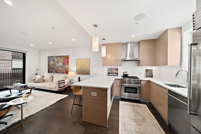 a kitchen with a sink stainless steel appliances and cabinets