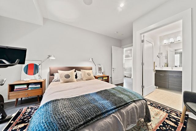 a bedroom with a bed and a view of kitchen