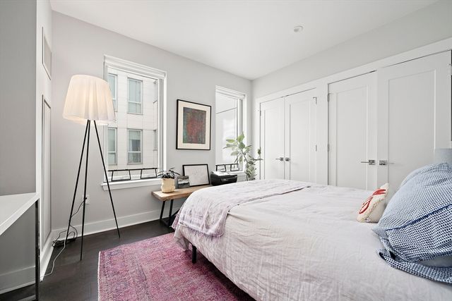 a bedroom with a bed and a potted plant