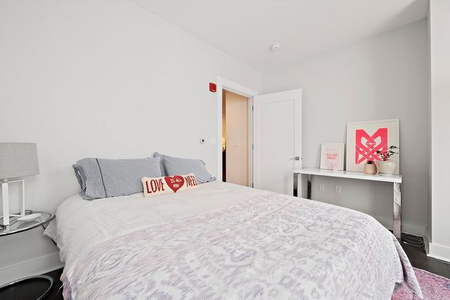 a bedroom with a bed and a book shelf