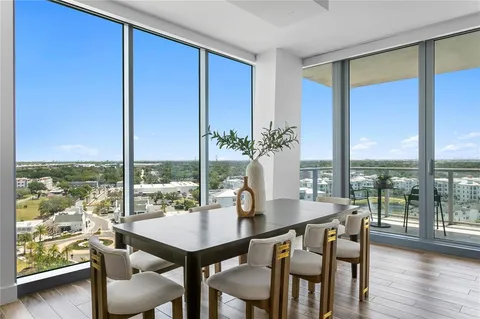 a kitchen with a dining table chairs and view living room
