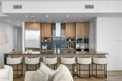 a kitchen with a dining table chairs and window