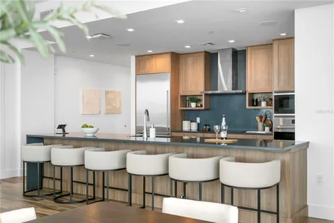 a dining room with furniture and a floor to ceiling window