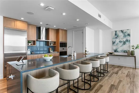 a kitchen with stainless steel appliances granite countertop a refrigerator and a sink