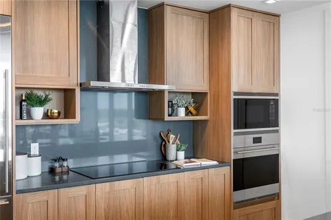a kitchen with lots of counter top space and wooden floor