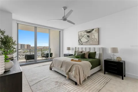 a bedroom with a bed and a painting on the wall