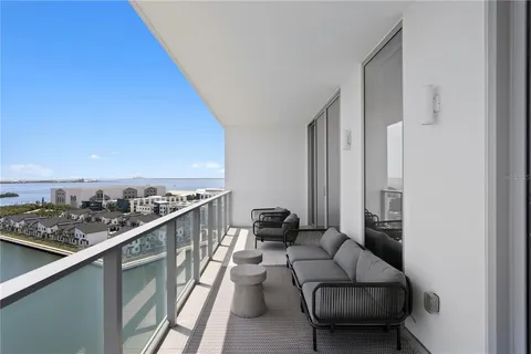 a view of a balcony with furniture and a floor to ceiling window