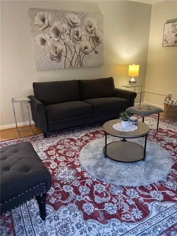a living room with a couch and a rug