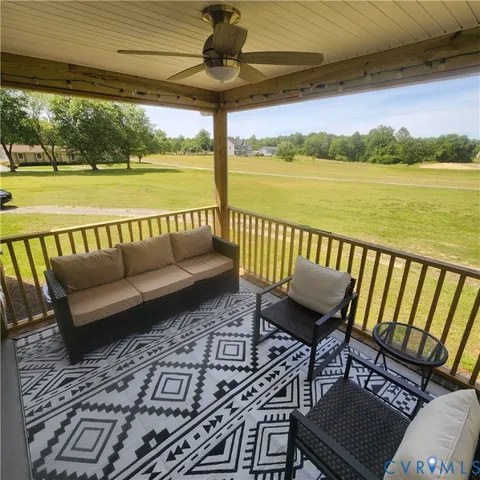 a balcony with couple of chairs and a stove