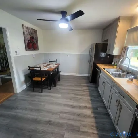 a view of a room with wooden floor and furniture