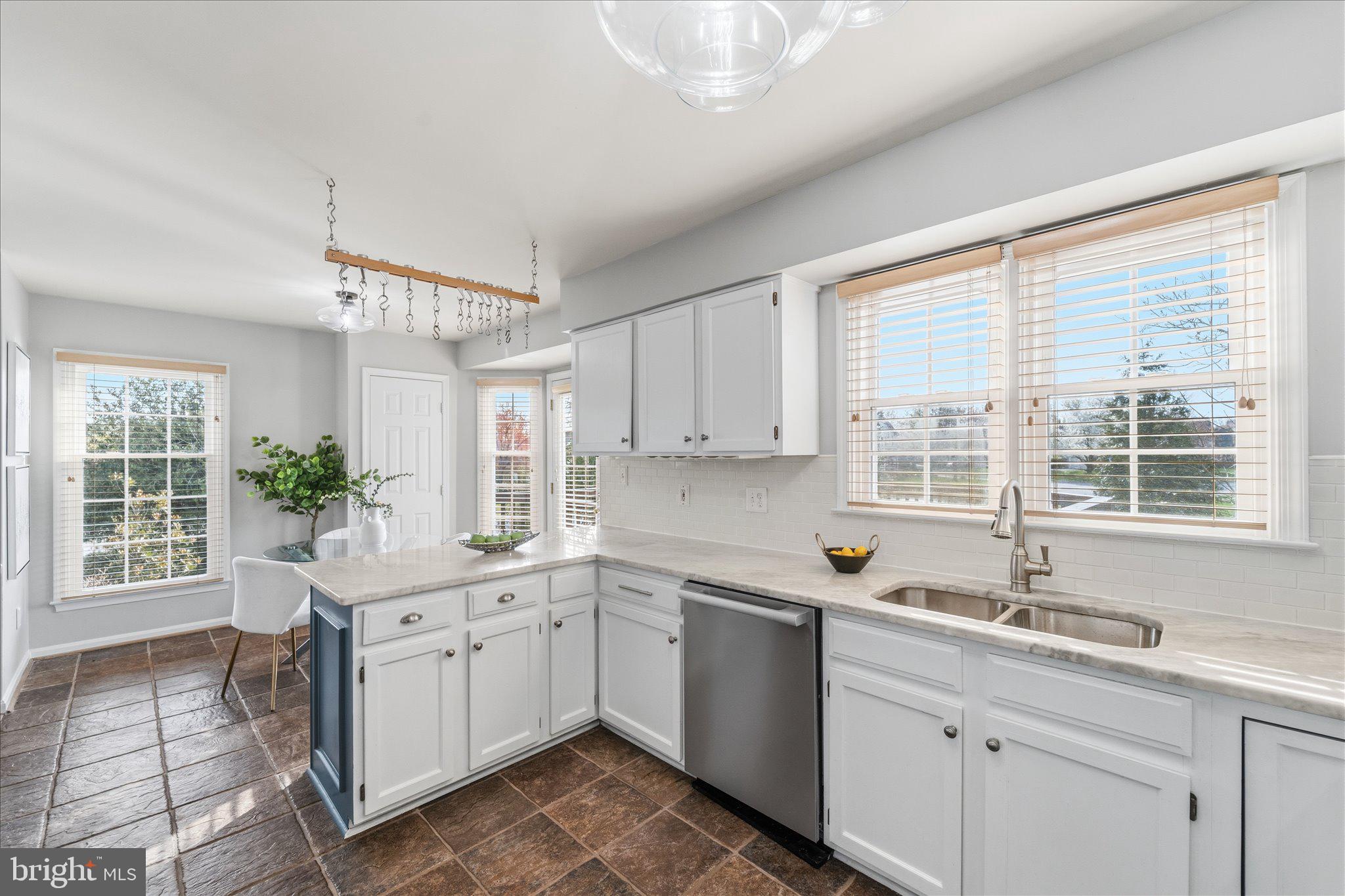 43451 Livery Square Ashburn, VA 20147 - Photo 13 of 51 a kitchen with a sink window and cabinets