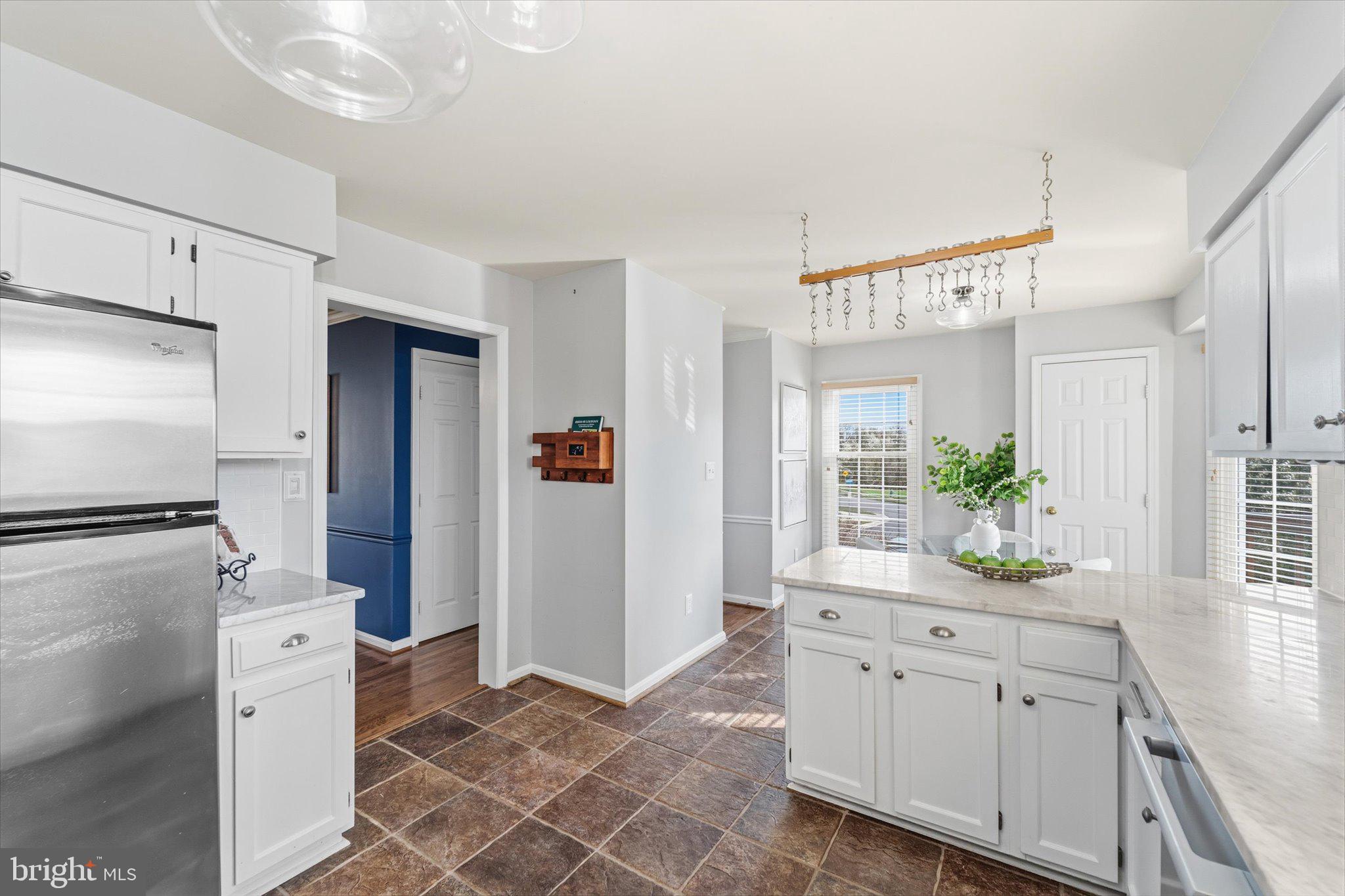 43451 Livery Square Ashburn, VA 20147 - Photo 14 of 51 a kitchen with white cabinets and refrigerator