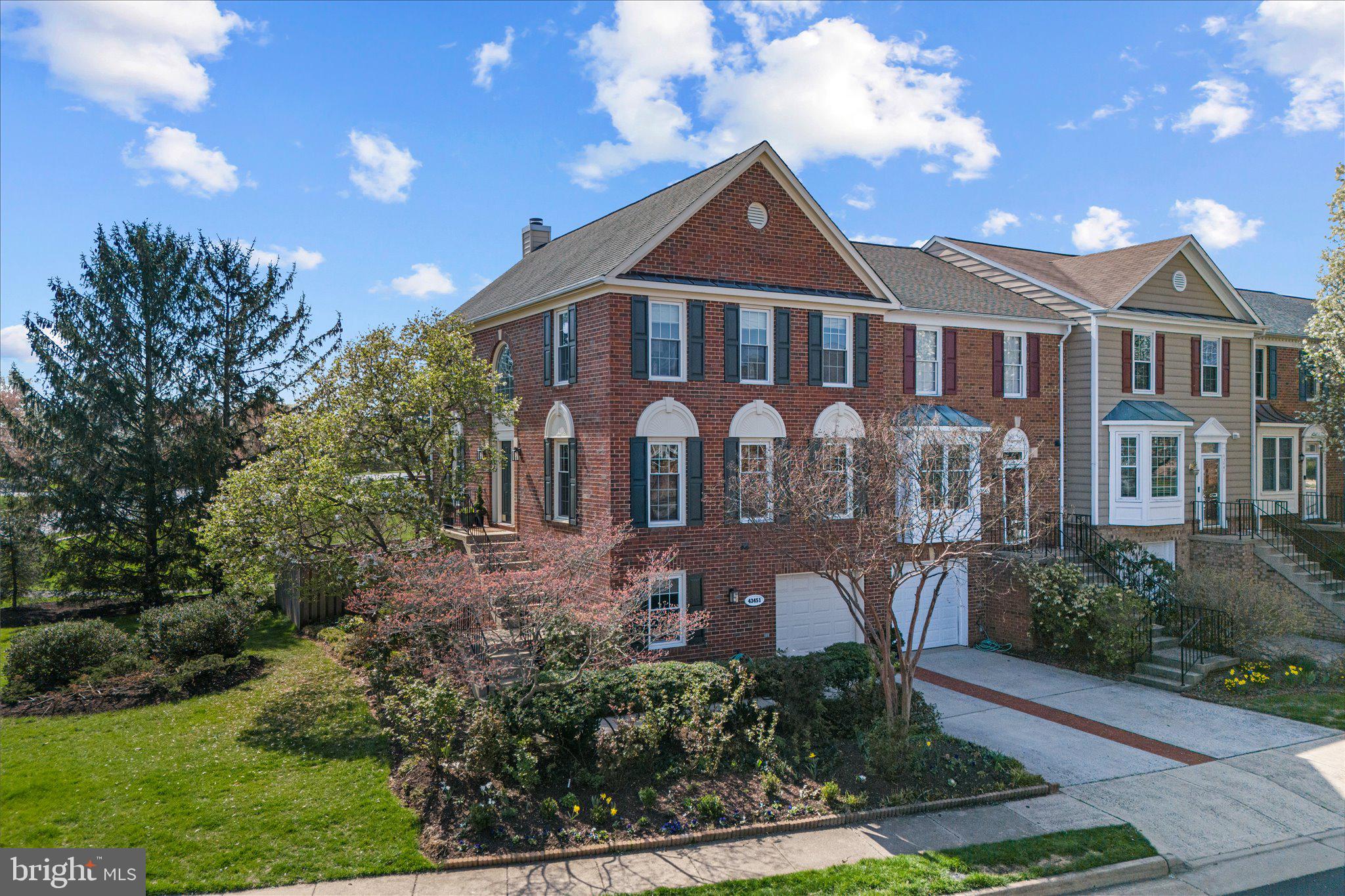 43451 Livery Square Ashburn, VA 20147 - Photo 2 of 51 a front view of a house with garden