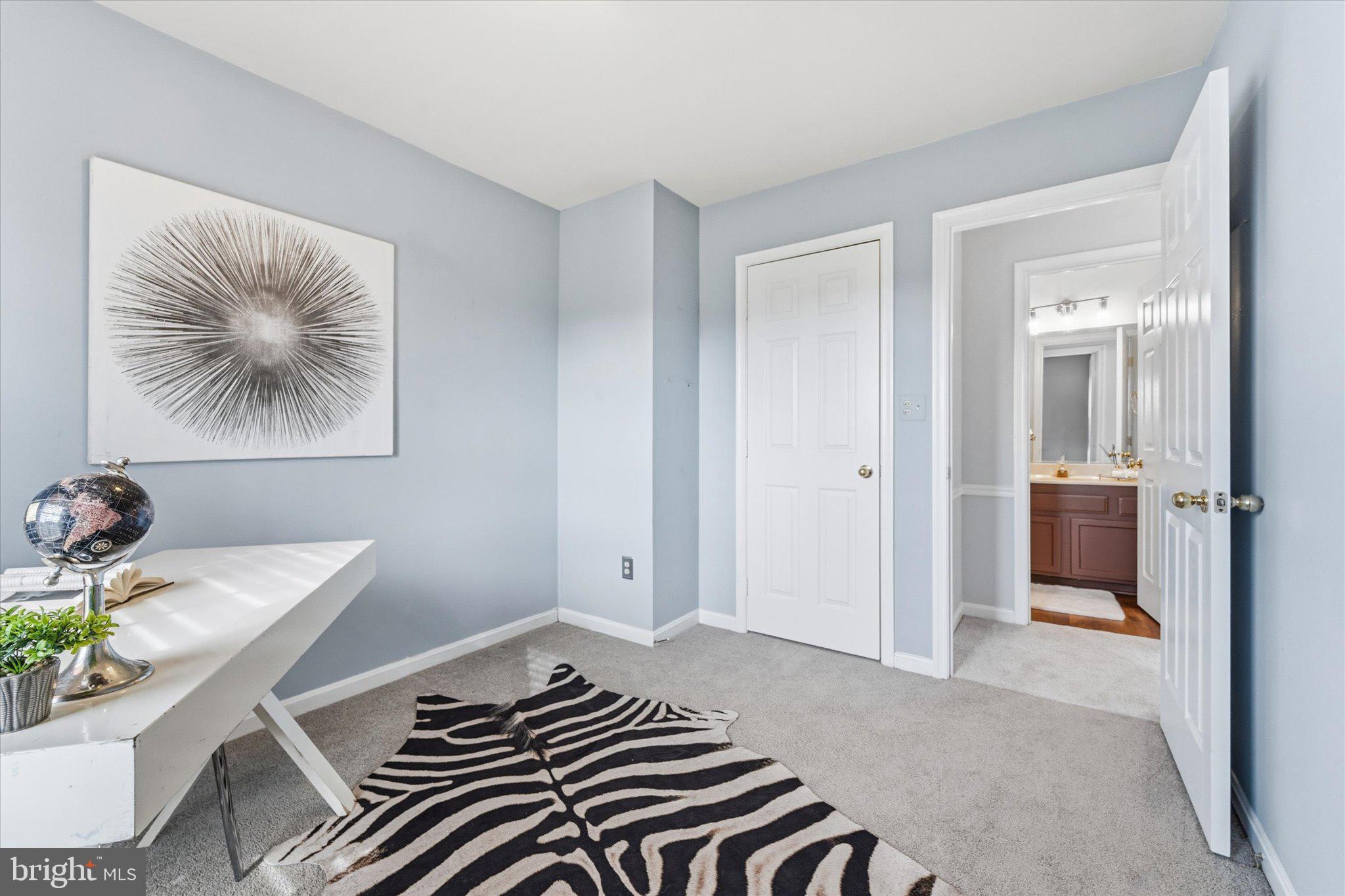 43451 Livery Square Ashburn, VA 20147 - Photo 35 of 51 a bedroom with a bed and a chandelier