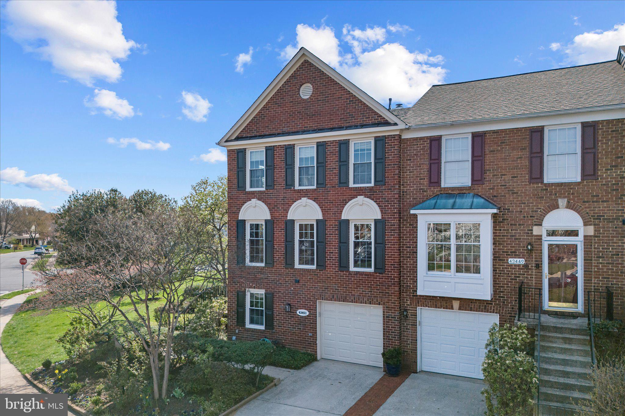 43451 Livery Square Ashburn, VA 20147 - Photo 4 of 51 a front view of a house with a yard and garage