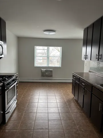 a kitchen with a stove a sink and a refrigerator