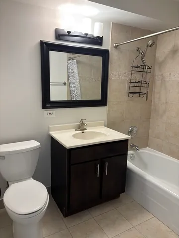 a bathroom with a sink vanity mirror and toilet