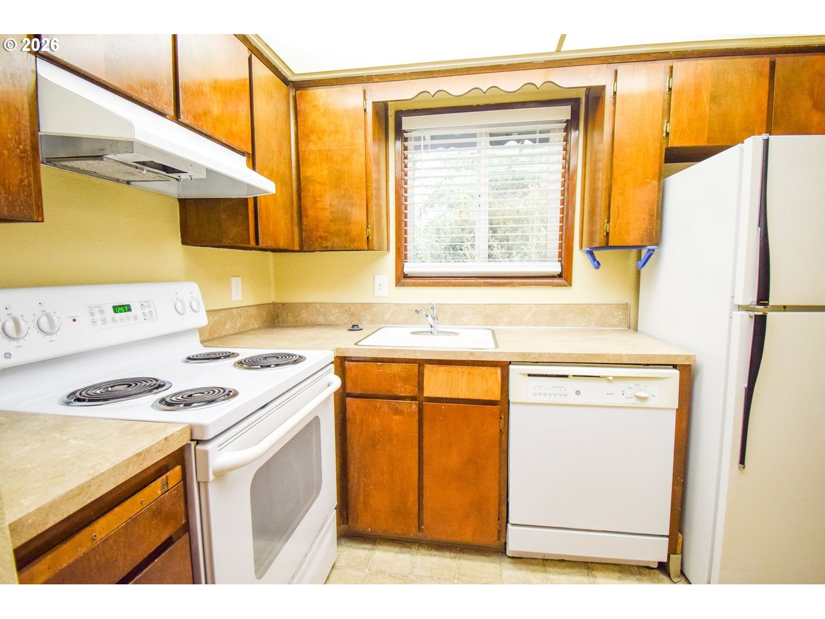 3124 19th Place Forest Grove, OR 97116 - Photo 16 of 31 a kitchen with a stove a sink and a refrigerator