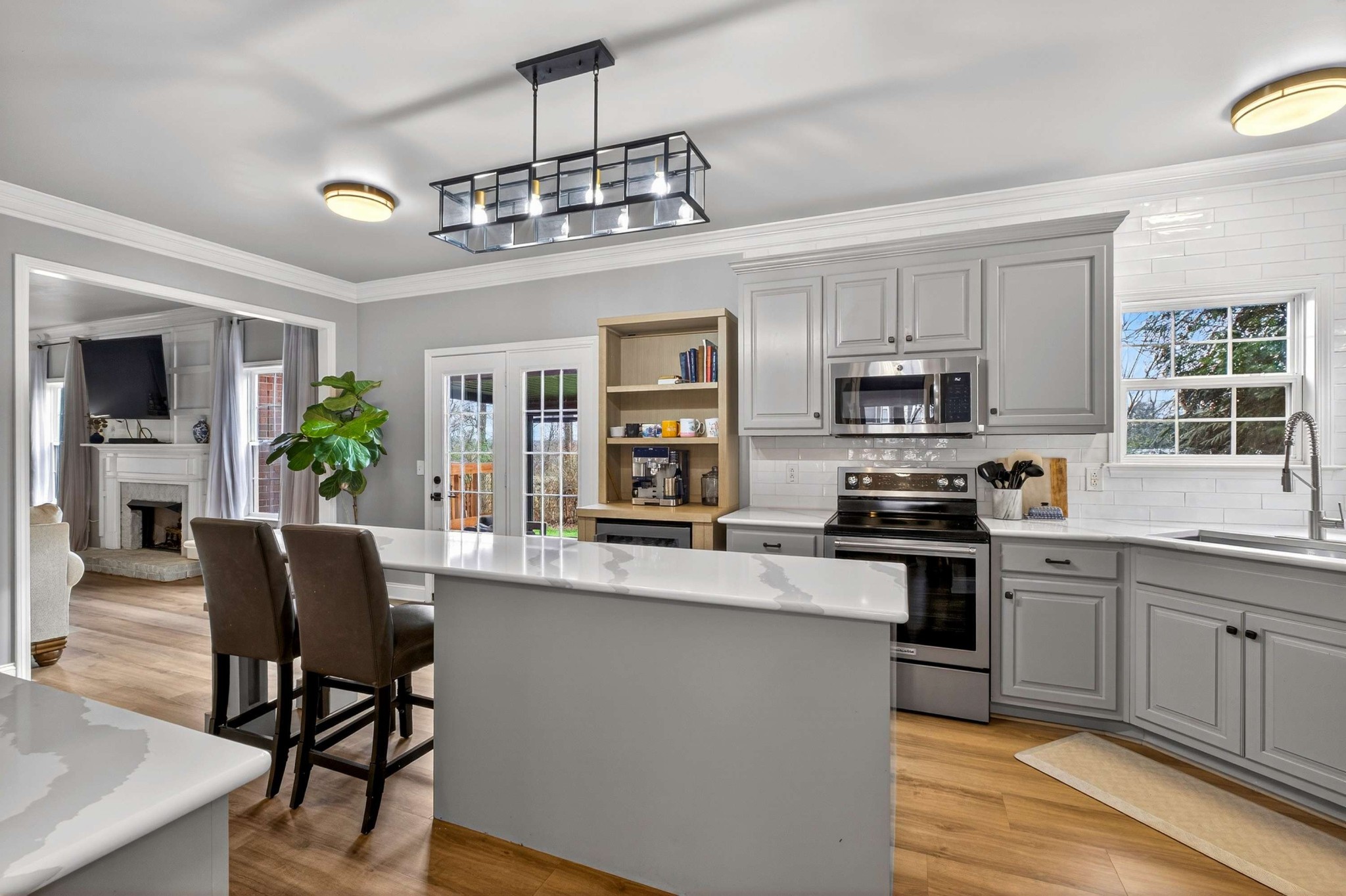 1012 Belcor Drive Spring Hill, TN 37174 - Photo 5 of 40 a kitchen with stainless steel appliances granite countertop a stove top oven a sink dishwasher a dining table and chairs with wooden floor