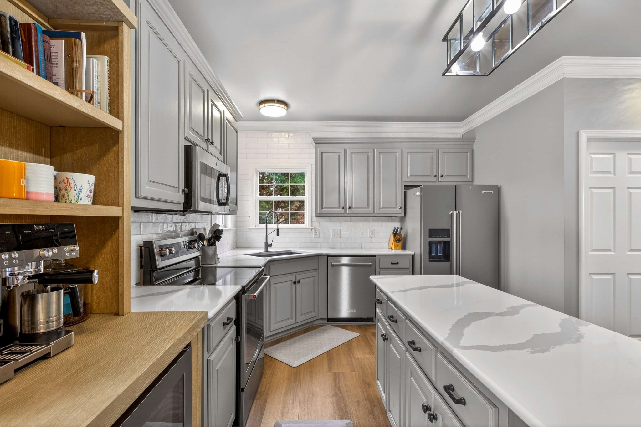 1012 Belcor Drive Spring Hill, TN 37174 - Photo 6 of 40 a kitchen with a sink a stove top oven a refrigerator cabinets and a dining table