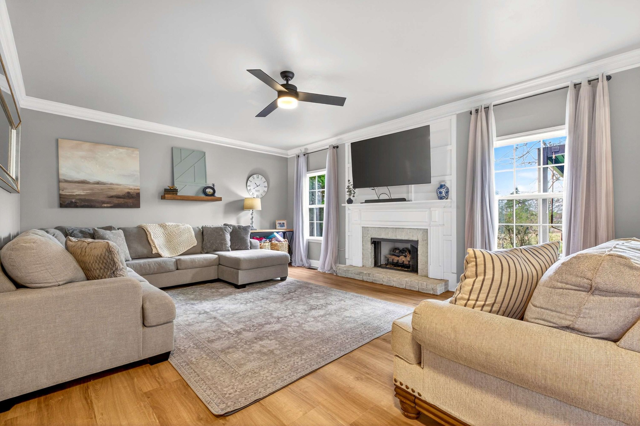 1012 Belcor Drive Spring Hill, TN 37174 - Photo 7 of 40 a living room with furniture a flat screen tv and a fireplace
