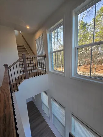 a view of entryway and hall with wooden floor