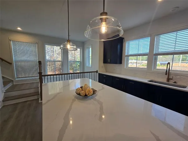 a kitchen with a chandelier and a sink