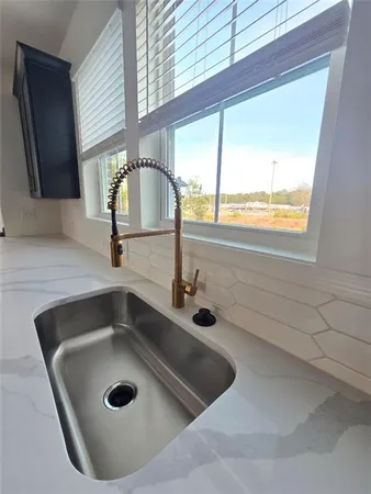 a bathroom with a sink and a window
