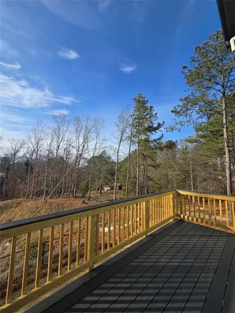 a view of a balcony with wooden fence