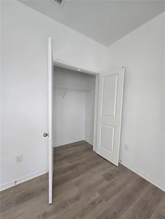 an empty room with wooden floor