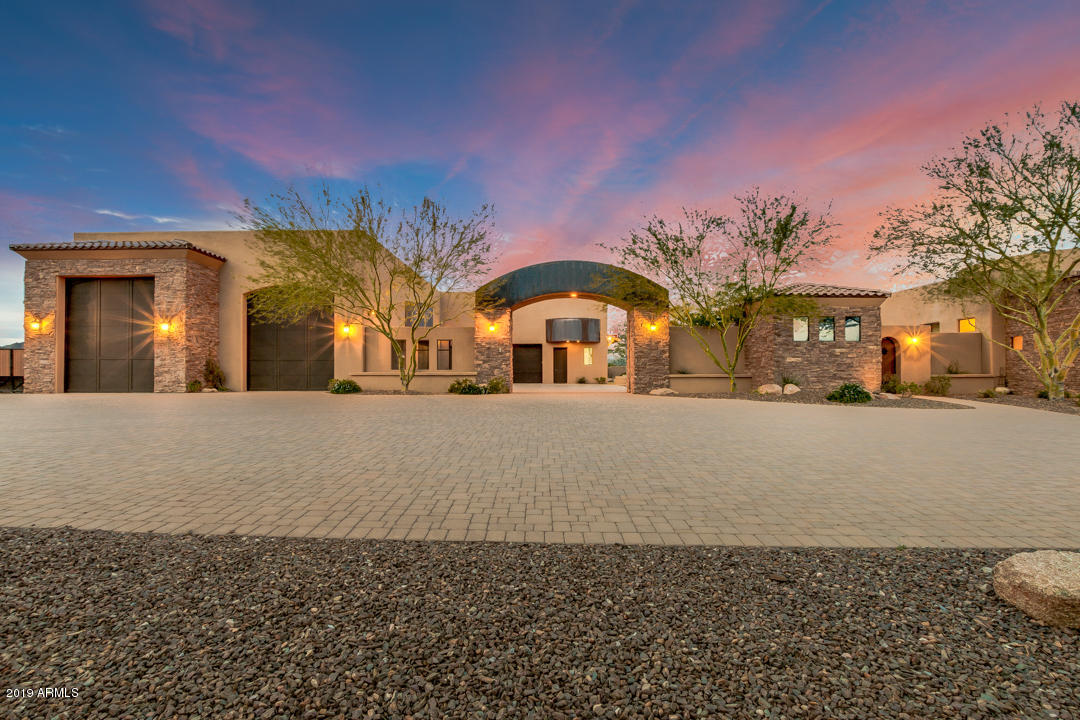 318 West Rock View Road Phoenix, AZ 85085 - Photo 1 of 105 a front view of a building with large trees