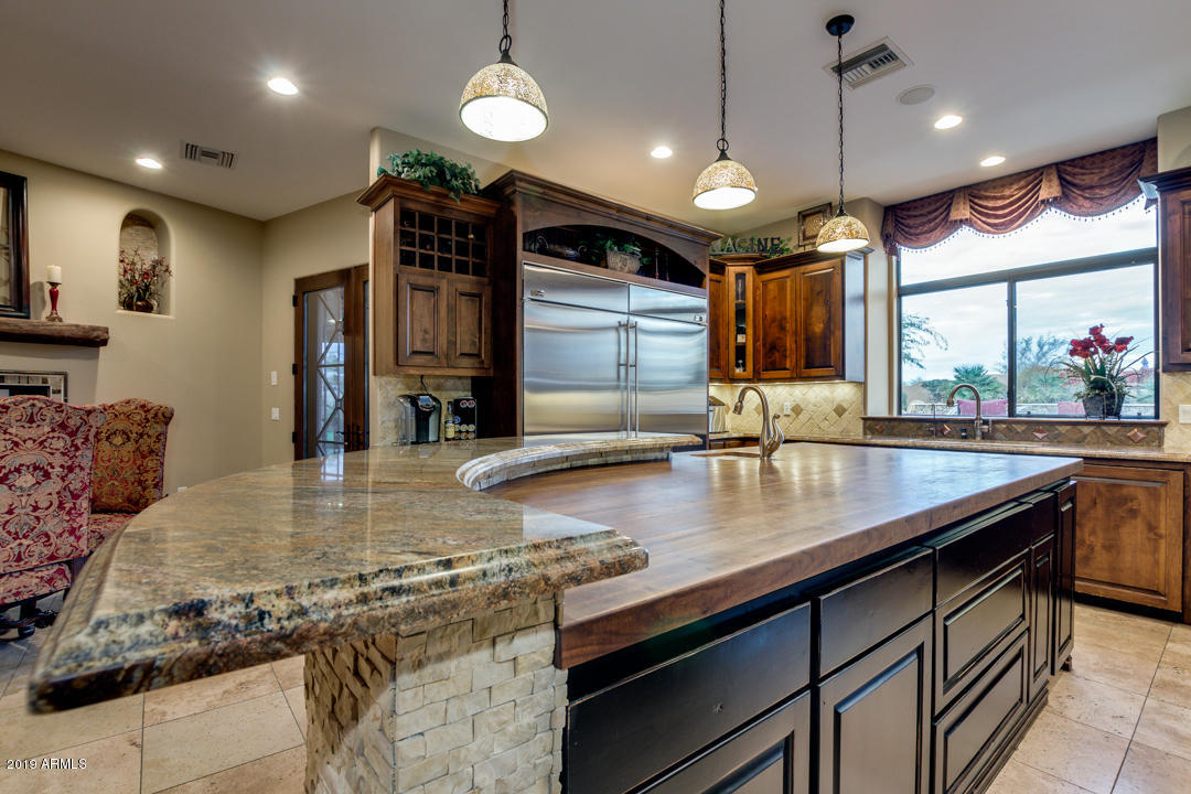 318 West Rock View Road Phoenix, AZ 85085 - Photo 33 of 105 a kitchen with stainless steel appliances granite countertop a sink a counter space and a view of living room