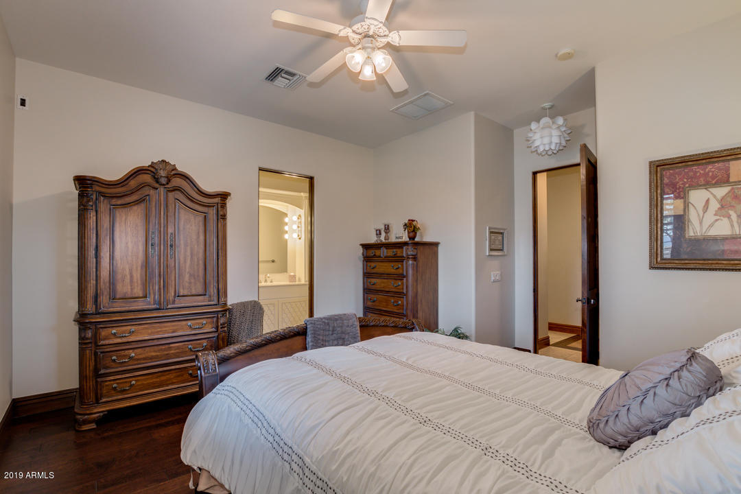 318 West Rock View Road Phoenix, AZ 85085 - Photo 50 of 105 a bedroom with a bed and a chandelier