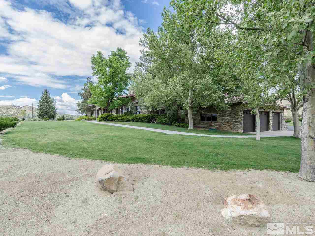 2450 Rhodes Road Reno, NV 89521 - Photo 5 of 25 a view of a house with a big yard and a large tree