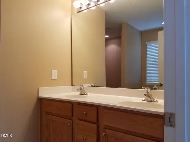 a bathroom with a granite countertop shower and a toilet