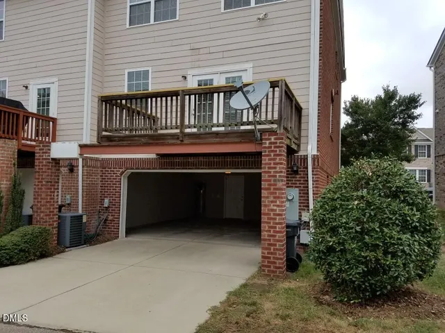 a view of a white house with a yard and table and chairs