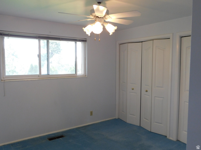 2148 Carolyn Way Bountiful, UT 84010 - Photo 14 of 40 Room featuring light blue wall paint, blue carpeting, and a white ceiling fan with integrated lighting
