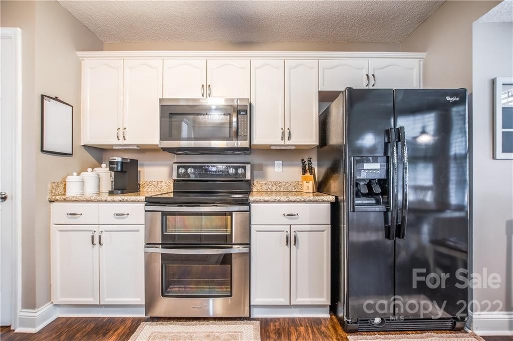 5901 Creft Circle Indian Trail, NC 28079 - Photo 11 of 26 a kitchen with a refrigerator and a stove