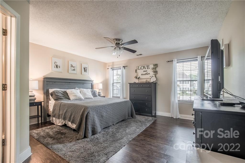 5901 Creft Circle Indian Trail, NC 28079 - Photo 12 of 26 a bedroom with a large bed and a chandelier